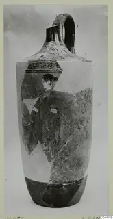 Tall jug with a pale white ground and a painted woman in profile, reassembled from fragments