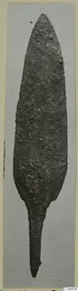 Corroded metal blade, leaf-shaped with a narrow tang, from Ayia Irini