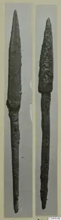 Two bronze weapons, long spearheads or daggers with tapering blades and tangs, each mounted on a grey card.