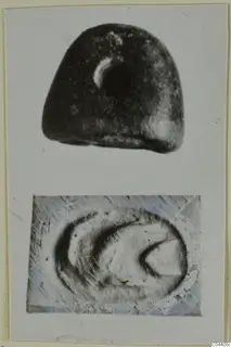 Dark stone seal with a pale crescent mark, shown with a close view of its flat face bearing a curved design