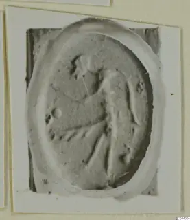 Oval seal or gem with a raised figure in low relief, photographed on a card mount