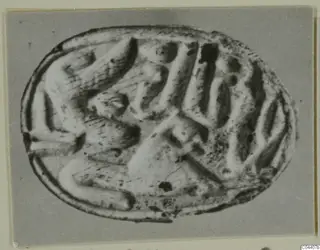 Oval stone seal with a carved design of curved and angular forms on its flat face