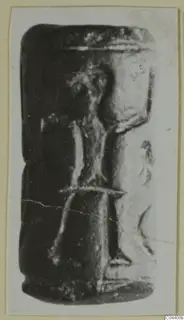 Glyptic: a dark cylinder seal from Ayia Irini, shown in side view on a photo card mount
