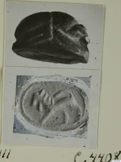 Two views of a stone scarab seal, its domed back above and its engraved flat base below, on a photo card