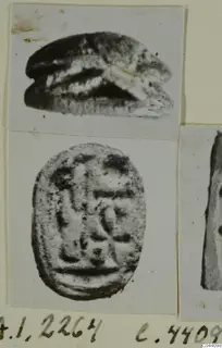 Scarab seal shown in side profile and from its flat base, with an incised design of signs on the base.