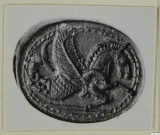 Oval engraved seal or gem showing a winged creature inside a beaded border