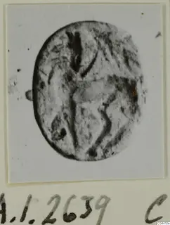 Oval seal or gem with a faint engraved design, shown face-on.