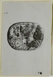 Engraved stone seal or gem from Ayia Irini, photographed on a pale card.