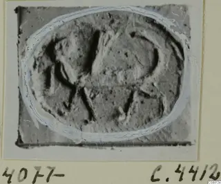Oval engraved seal or gem from Ayia Irini, shown enlarged on a mounted card
