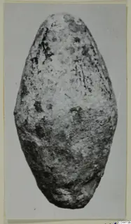 Ovoid lead object from Idalion, corroded and pitted, narrower at the top