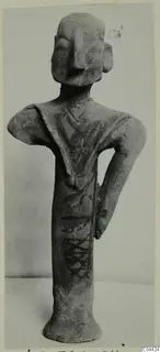 Terracotta figurine of a standing figure with one hand on the hip and dark painted bands, from Ayia Irini