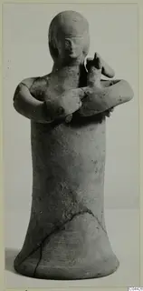 Terracotta statuette of a standing figure with arms crossed over the chest, shown from the front