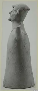 Terracotta figurine with a bell-shaped body and a head in profile facing left