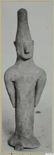 Terracotta figurine of a standing figure with a tall head and arms held at its sides