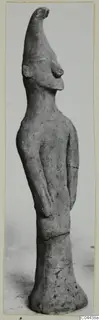 Terracotta figurine of a standing figure from Ayia Irini, with a tall pointed head and arms held at the sides