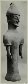 Terracotta figure of a standing human figure with a tall pointed cap and flared base, from Ayia Irini