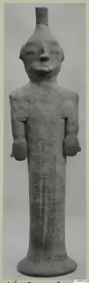 Terracotta figure of a standing human with arms at the sides and a tall flared base, from Ayia Irini