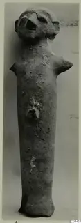 Terracotta figurine of a standing human figure with a pinched face, stub arms and a small knob at the middle of the body