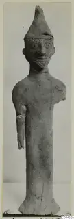 Terracotta figurine of a standing bearded figure in a tall pointed hat, from Ayia Irini