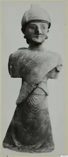 Terracotta statue of a bearded standing figure in a rounded cap, arms broken off, from Ayia Irini