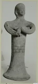 Terracotta figurine of a standing figure with arms bent and hands clasped at the chest