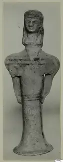 Terracotta figurine of a standing figure from Ayia Irini, front view against a plain background