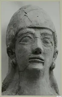 Terracotta Neo-Cypriote head, front view, with cracks across the crown and cheek