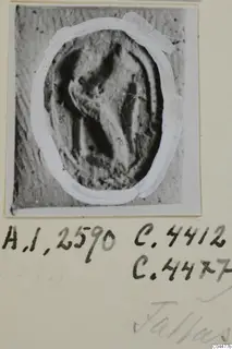 Oval seal or gem with an incised design, shown as a print on a photo card with handwritten notes