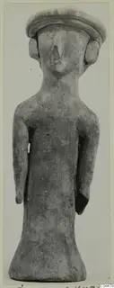 Terracotta figurine of a standing figure with a broad flat cap-like head and arms held at its sides.