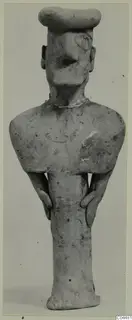 Terracotta figurine of a standing human figure with a flat-topped head and arms held at the sides.