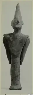 Terracotta figurine of a standing figure with a tall pointed headdress and arms held at its sides, from Ayia Irini