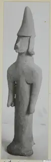 Terracotta figurine of a standing figure with a tall conical head covering, from Ayia Irini