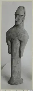 Terracotta figure from Ayia Irini with a cap-like head and short stubby arms.