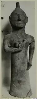 Terracotta standing figure with one arm across the chest holding a small animal-like form, the other arm hanging at the side