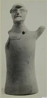 Terracotta figure of a human head and upper body with one arm raised, photographed against a pale background