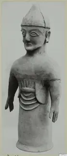 Terracotta standing figure with a pointed cap and arms held out from the body, from Ayia Irini