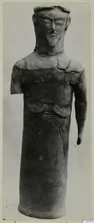 Terracotta standing figure from Ayia Irini with a cylindrical body and one arm broken off