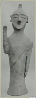Terracotta figure with a raised arm and a dark diagonal band across the body, from Ayia Irini