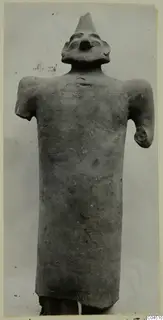 Terracotta figure with a tall conical top to the head and stubby arms, from Ayia Irini