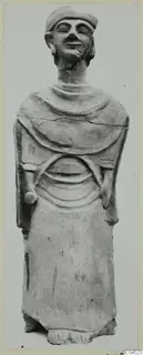 Terracotta statue, Proto-Cypriote II, a standing figure with closed eyes, a close-fitting cap and bent arms