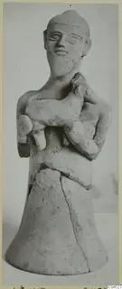 Terracotta figurine of a standing human figure holding a small animal against its chest, on a flared base