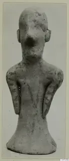 Terracotta figurine of a standing human figure with a large nose and arms held close to the sides, from Ayia Irini.