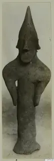 Terracotta figurine with a tall pointed head and long arms held out from the body, from Ayia Irini
