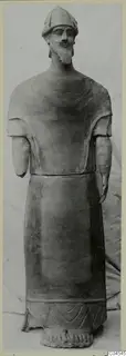 Terracotta statue of a bearded standing man in a close-fitting cap, forearms broken off, from Ayia Irini