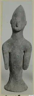 Terracotta figurine of a standing figure with a pointed head and arms at its sides, from Ayia Irini