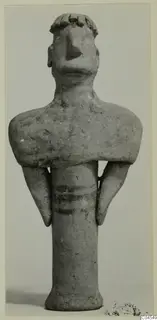 Terracotta figurine of a standing figure with a broad head, arms held at the sides and three painted bands on the body.