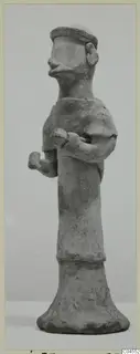 Standing terracotta figurine from Ayia Irini with bent arms and a flat-topped head