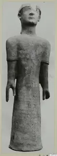 Terracotta Proto-Cypriote II, a standing figure with arms bent at the elbows and a long cylindrical body