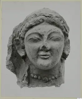 Terracotta head of a woman with a bead necklace, eyes half-closed and a slight smile, broken at the sides and back.