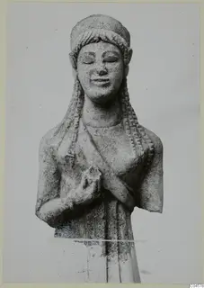 Limestone statue from Arsos of a female figure with braided hair, eyes closed and hands clasped at the chest